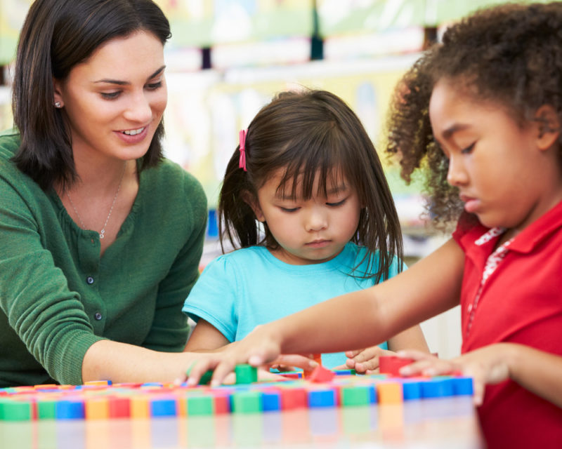 teacher playing with 2 kids