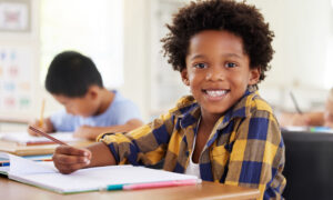 student smiling at desk