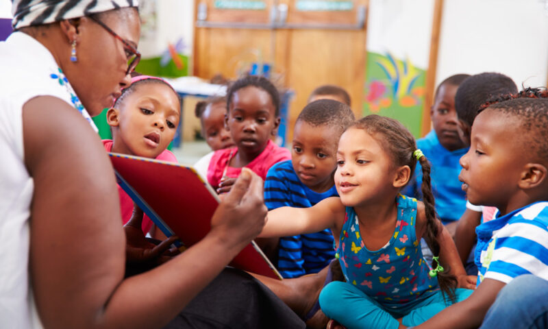kids looking at a book
